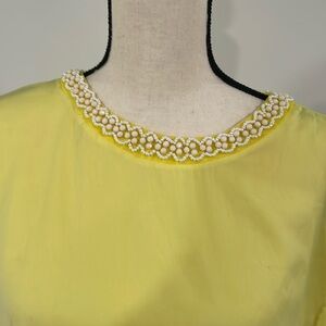 Yellow silk blouse with beaded neckline.